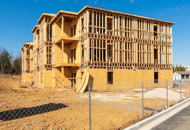 construction zone secured with a temporary fence, marked with warning signs in Ellisville, MO